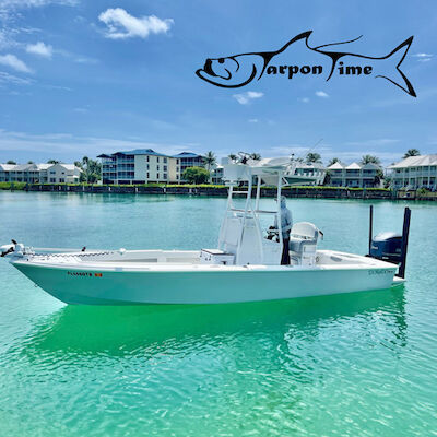 The image shows a white fishing boat on clear turquoise water, with buildings and palm trees in the background and a logo of a fish saying "Tarpon Time."